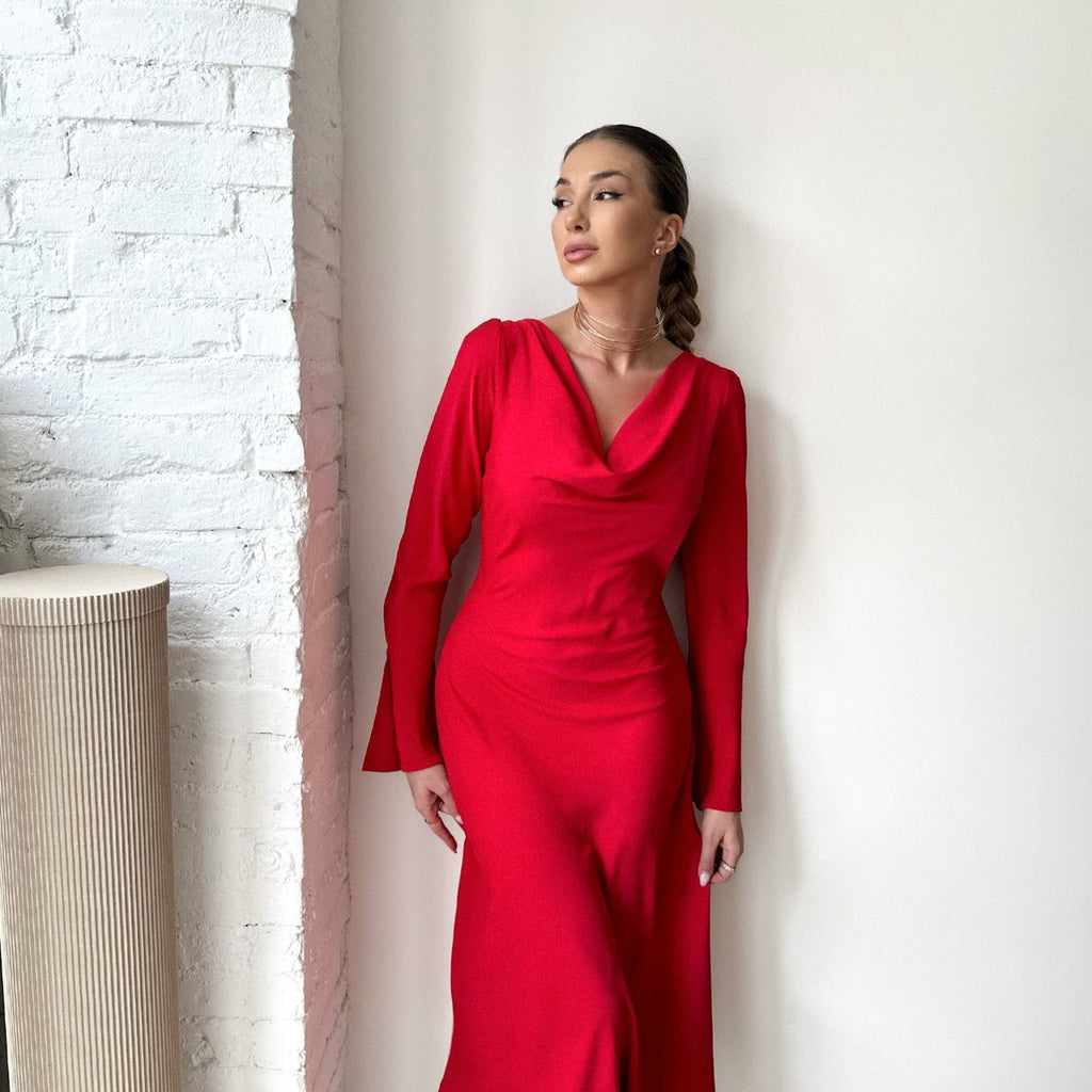 woman wearing red dress standing against white wall woman wearing red dress standing against white wall