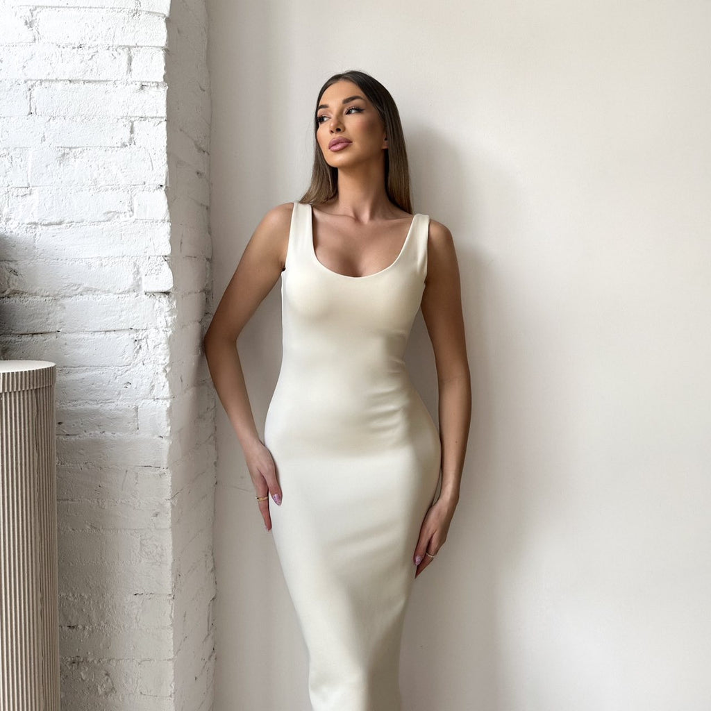 woman in sleeveless white midi dress woman in sleeveless white midi dress