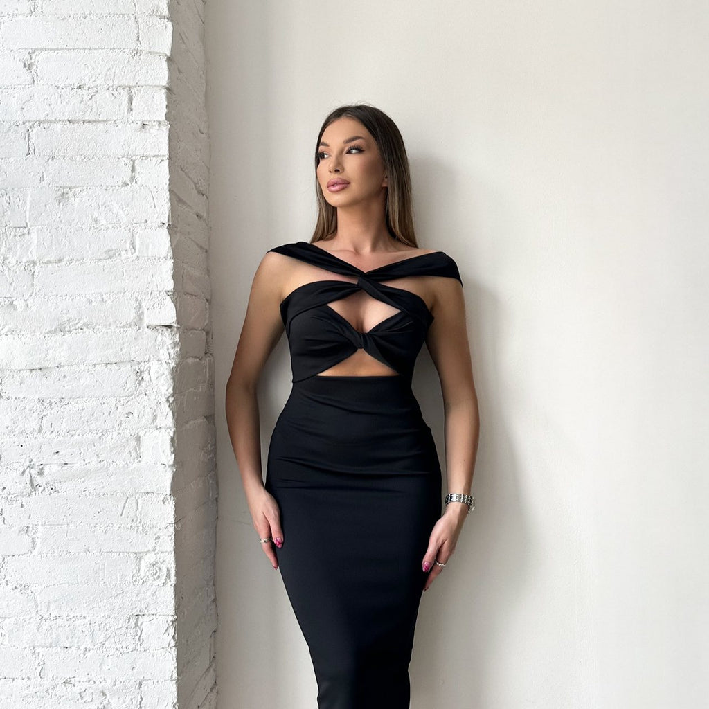 black dress with cutouts against white background black dress with cutouts against white background