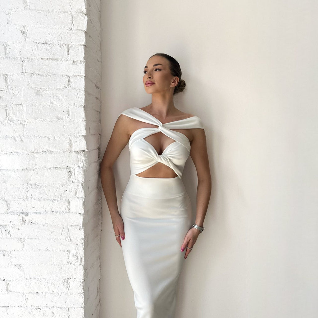 model wearing elegant white cutout dress model wearing elegant white cutout dress