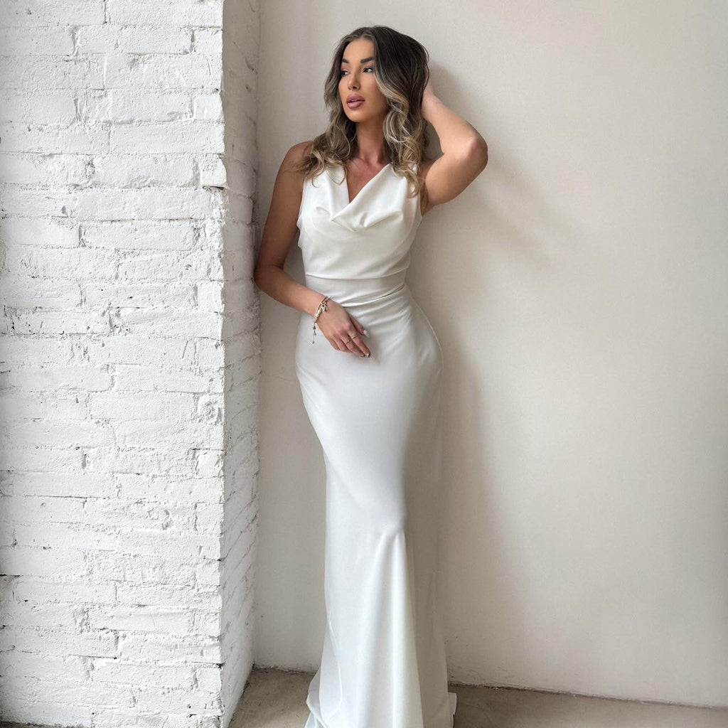 long white evening gown posed against brick wall long white evening gown posed against brick wall