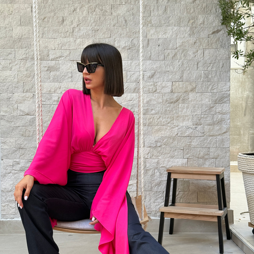 woman in pink top and black pants sitting on swing woman in pink top and black pants sitting on swing