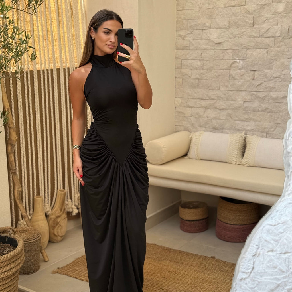 woman wearing black maxi dress in stylish room woman wearing black maxi dress in stylish room