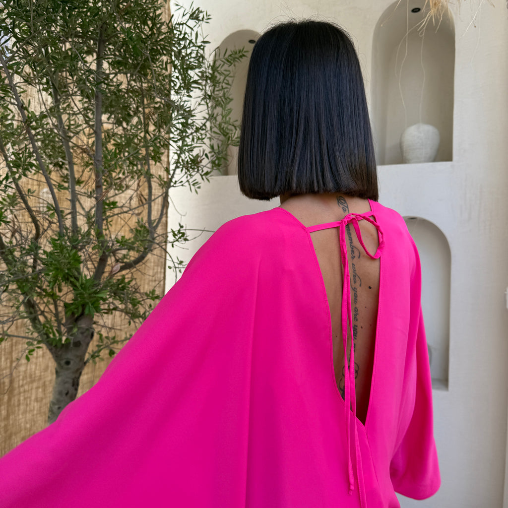 woman in pink open back dress woman in pink open back dress
