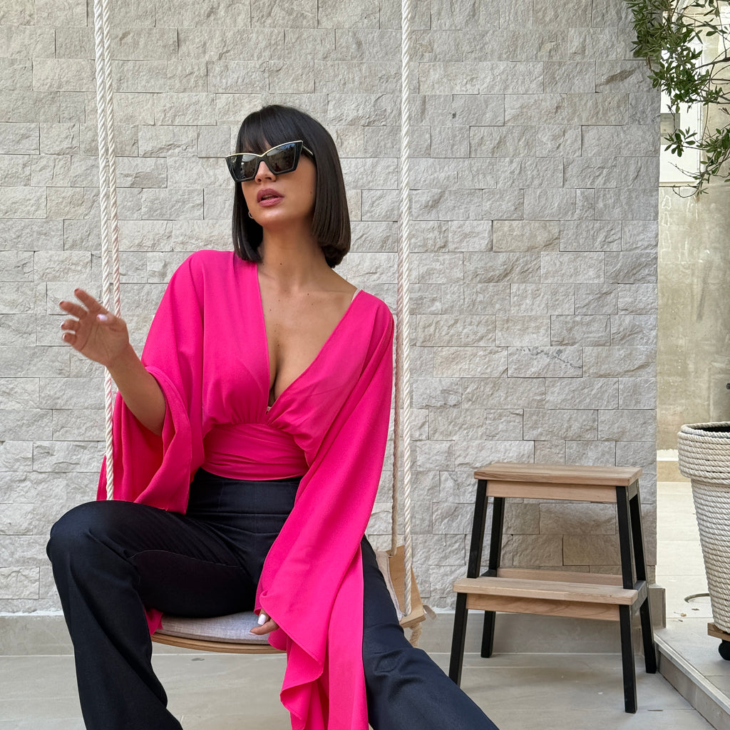 woman in pink blouse and black pants sitting on swing woman in pink blouse and black pants sitting on swing
