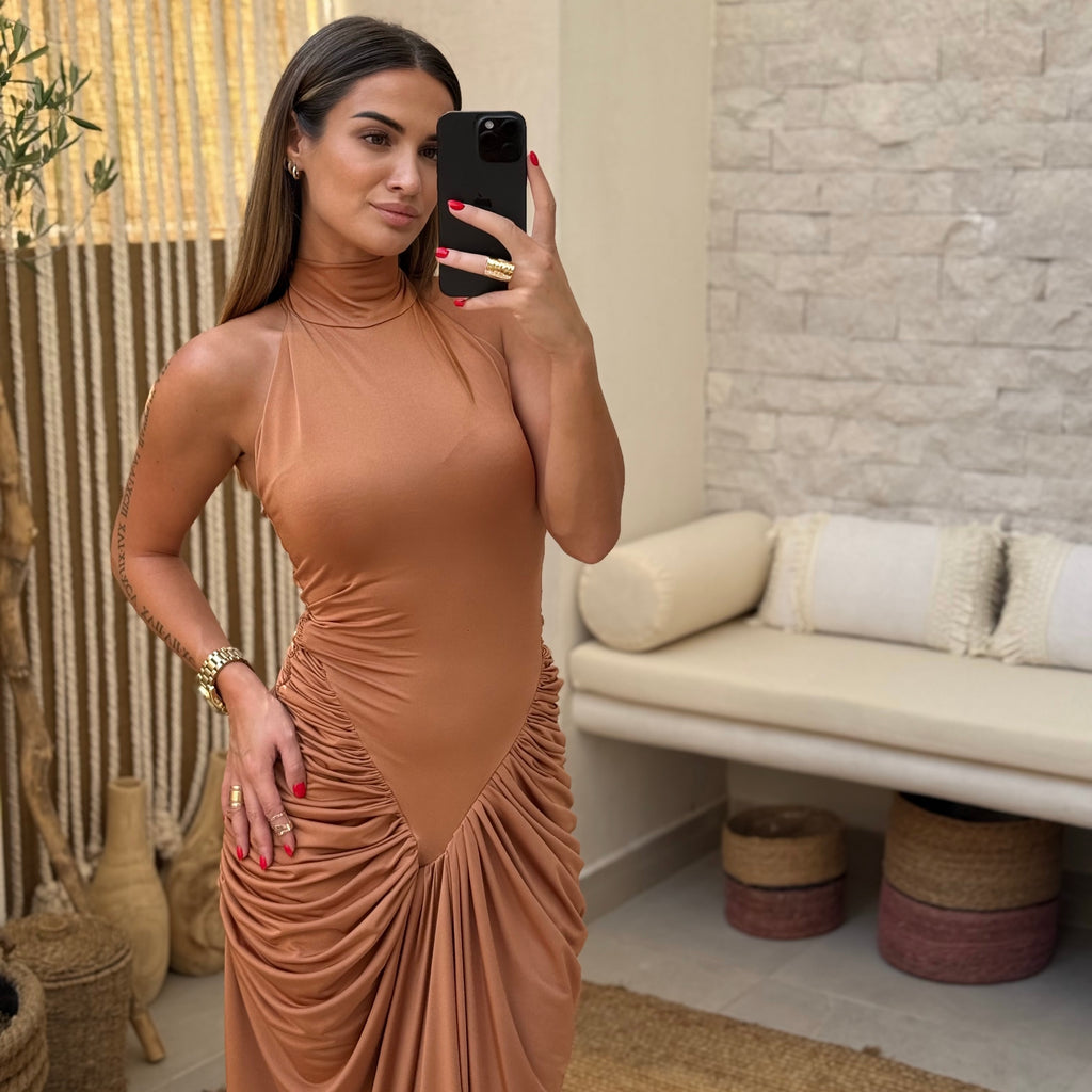 woman in brown draped dress taking selfie woman in brown draped dress taking selfie