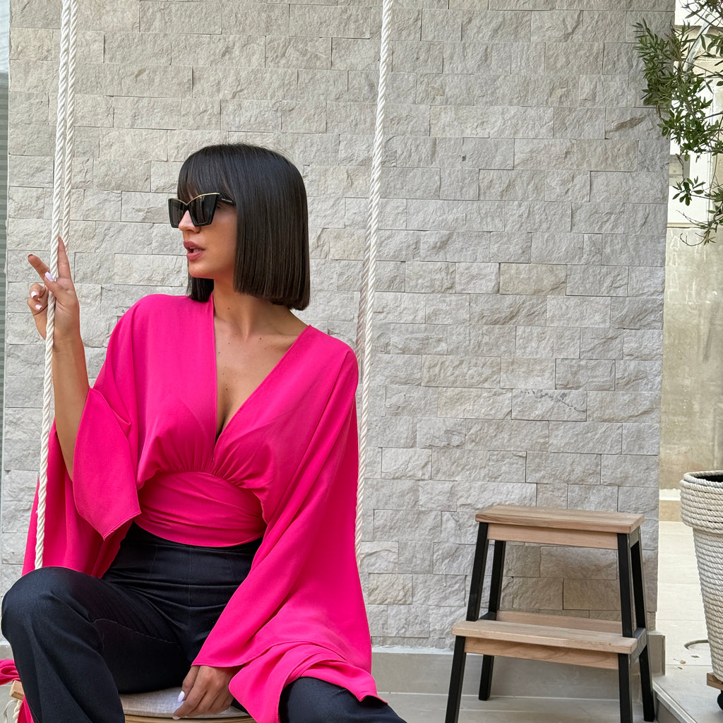 woman in a pink blouse and black pants on a swing woman in a pink blouse and black pants on a swing
