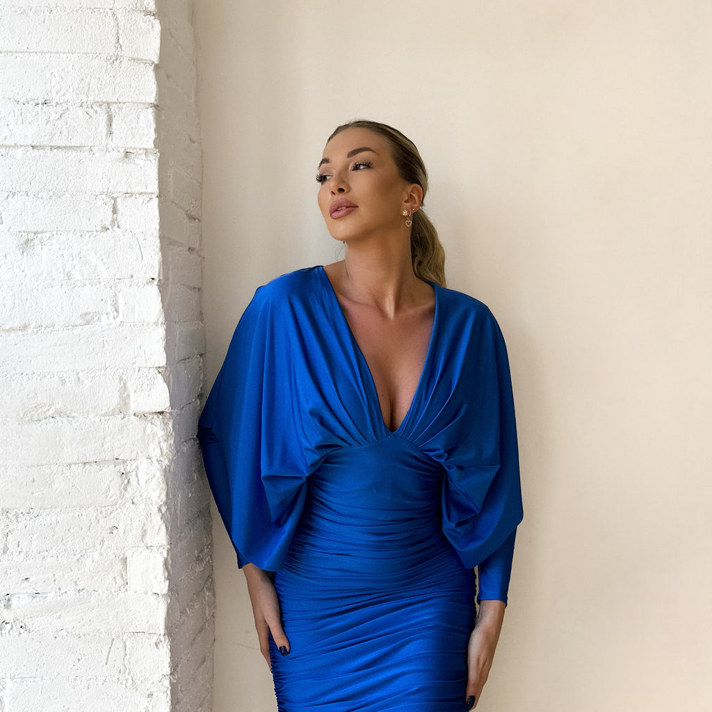woman wearing blue draped dress woman wearing blue draped dress