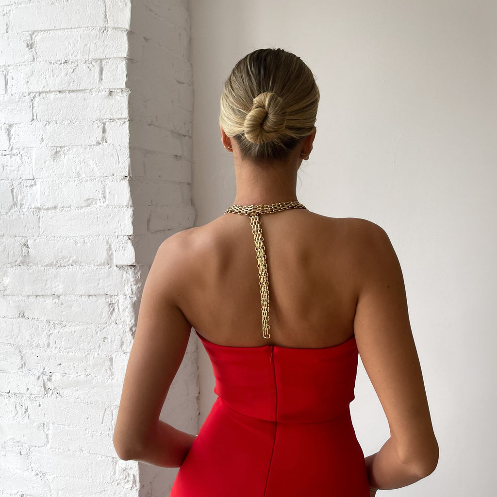 woman in red strapless dress back view woman in red strapless dress back view