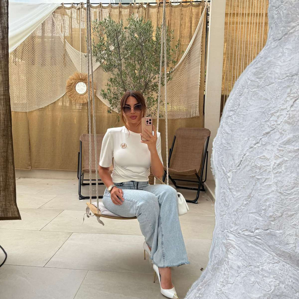 white top and jeans outfit on a swing white top and jeans outfit on a swing
