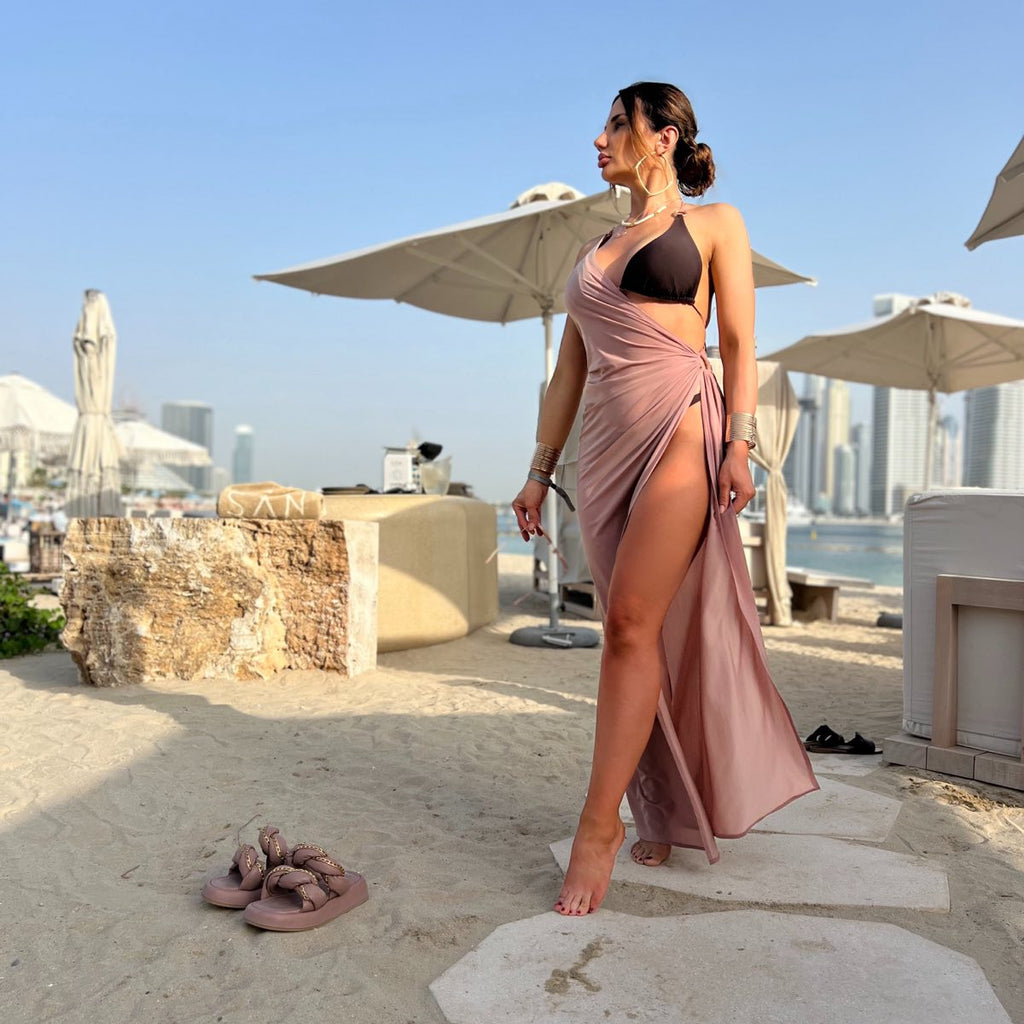 woman in pink wrap dress on beach woman in pink wrap dress on beach