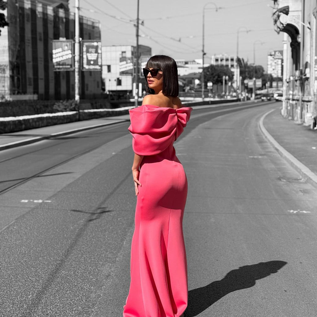 woman in off shoulder pink dress on street woman in off shoulder pink dress on street