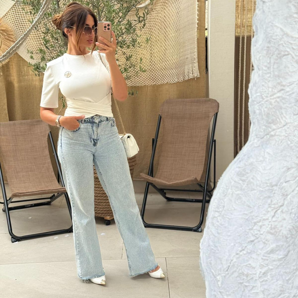 woman in white top and jeans taking mirror selfie woman in white top and jeans taking mirror selfie