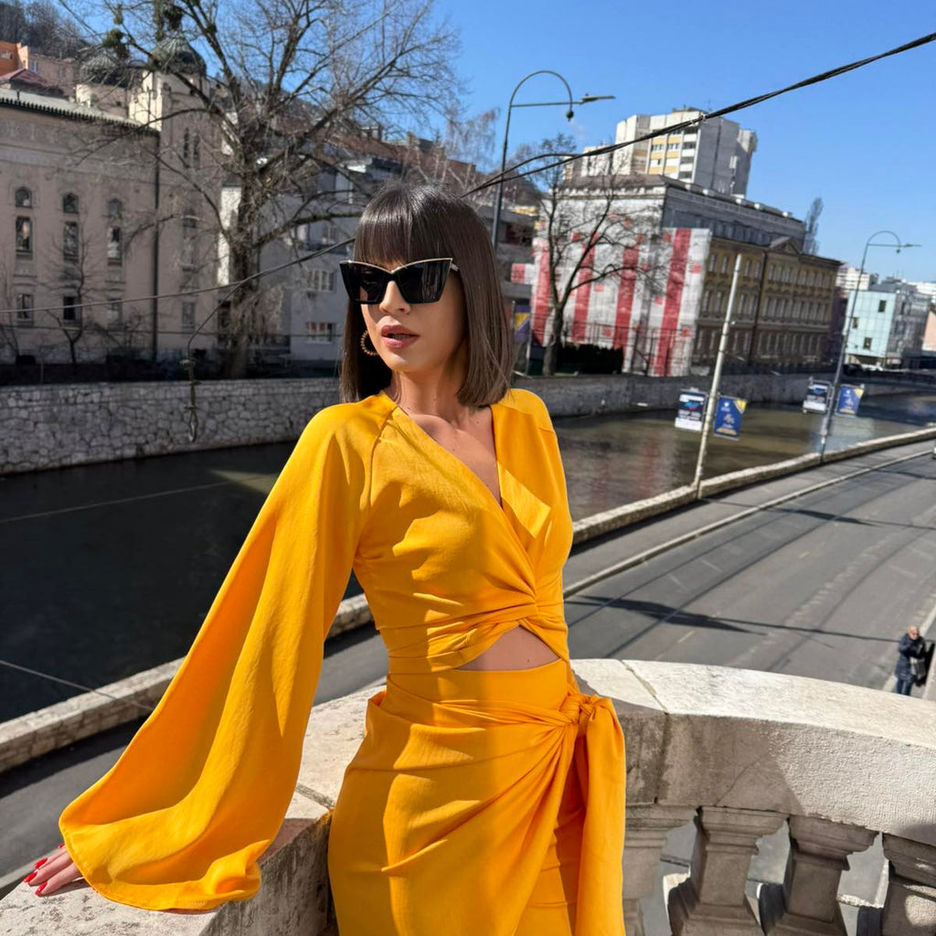 yellow dress on balcony with city view yellow dress on balcony with city view