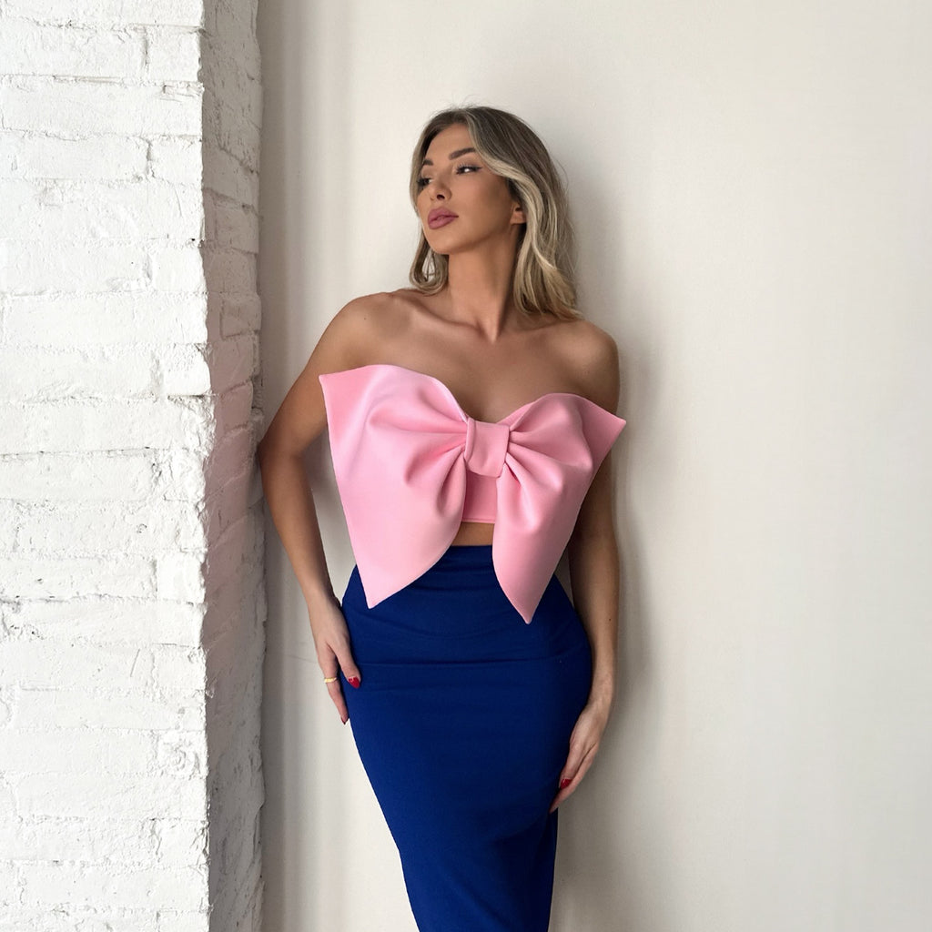woman wearing pink bow top and blue skirt woman wearing pink bow top and blue skirt