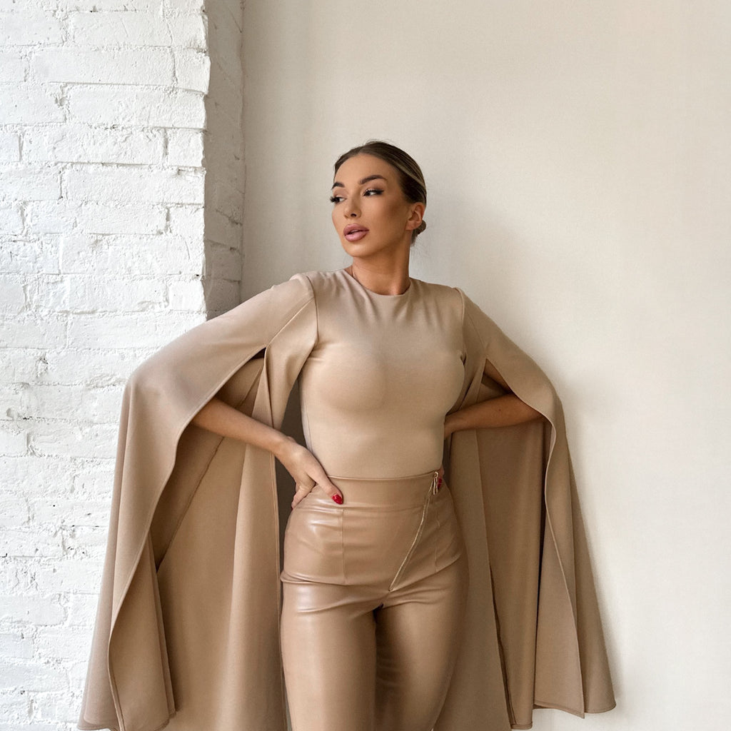 beige cape sleeve top and leather pants on model beige cape sleeve top and leather pants on model