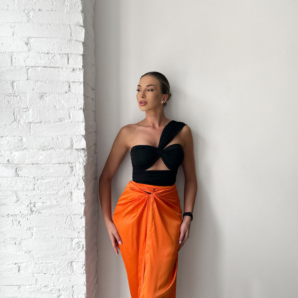 woman wearing black and orange one shoulder dress woman wearing black and orange one shoulder dress