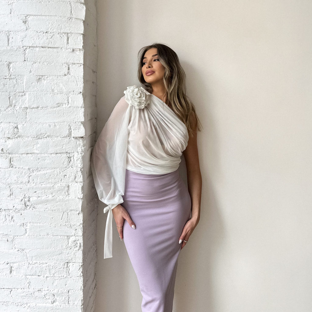 woman wearing white one shoulder top and lilac skirt woman wearing white one shoulder top and lilac skirt