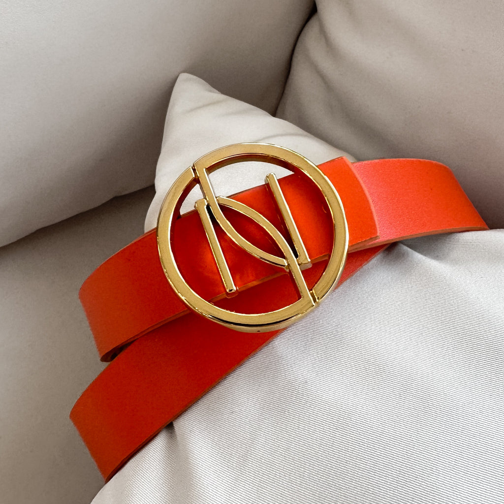 orange belt with gold buckle on cushion orange belt with gold buckle on cushion