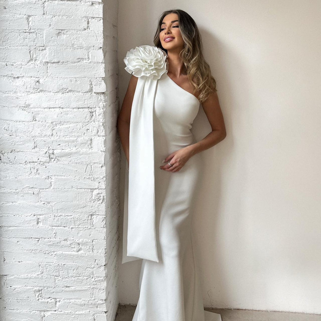 woman in one shoulder white dress with floral detail woman in one shoulder white dress with floral detail