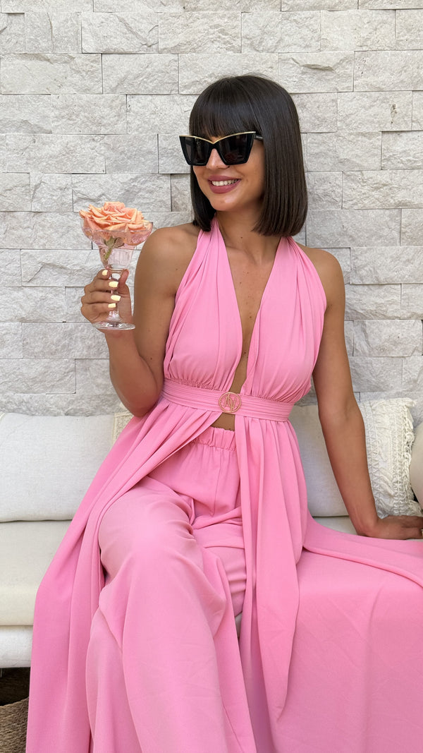 woman in pink halter dress holding rose glass