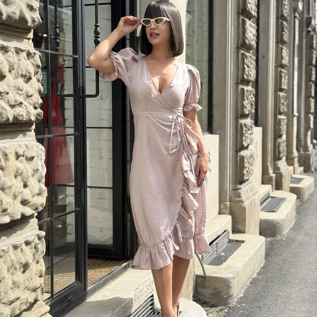 beige wrap dress with ruffle details worn by woman in sunglasses standing outside beige wrap dress with ruffle details worn by woman in sunglasses standing outside