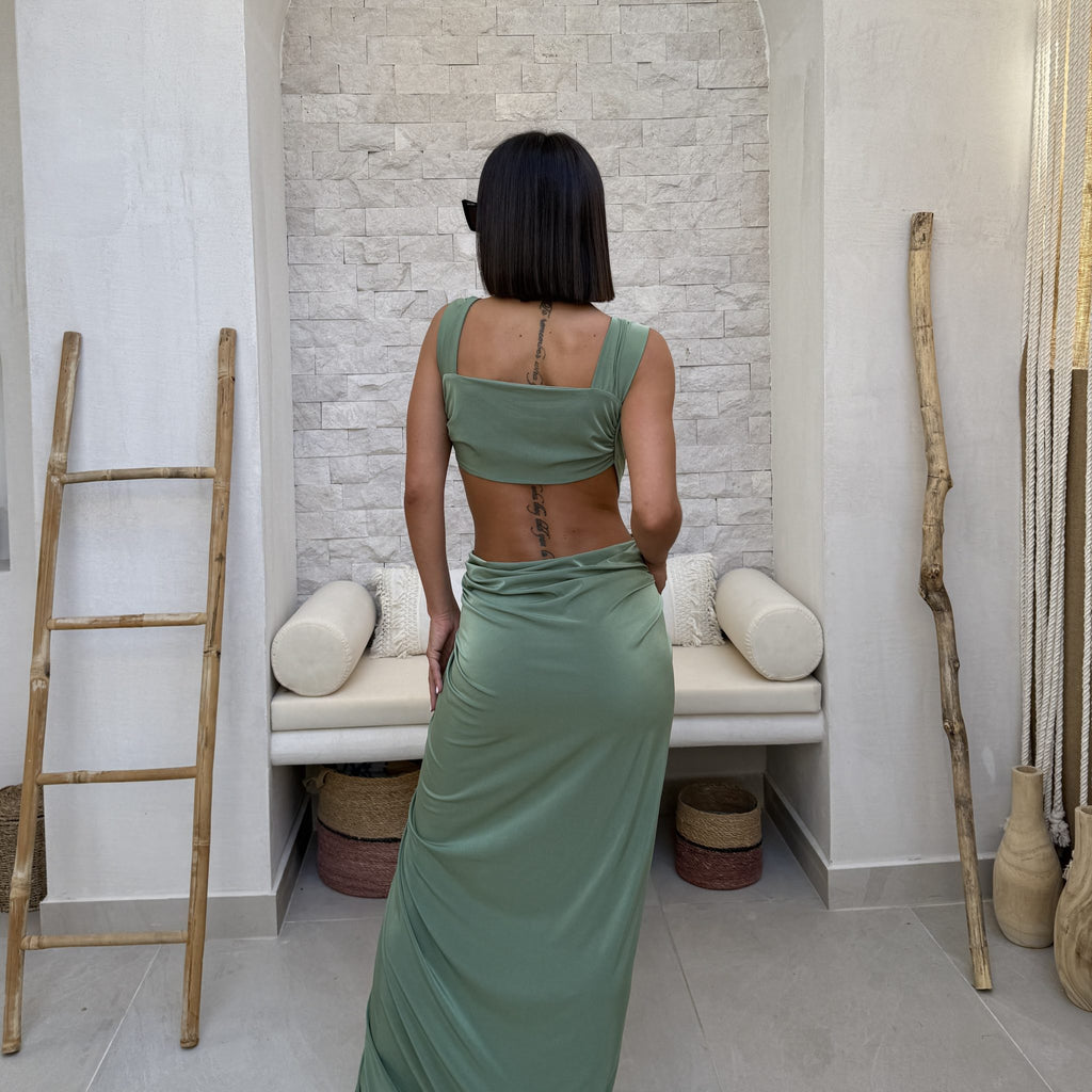 woman wearing backless green maxi dress woman wearing backless green maxi dress