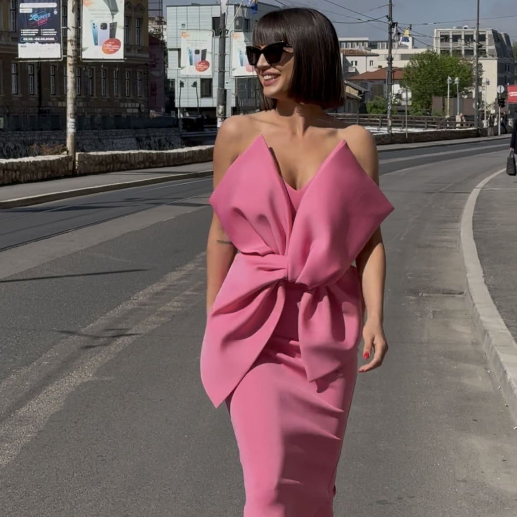 woman wearing pink dress on city street woman wearing pink dress on city street