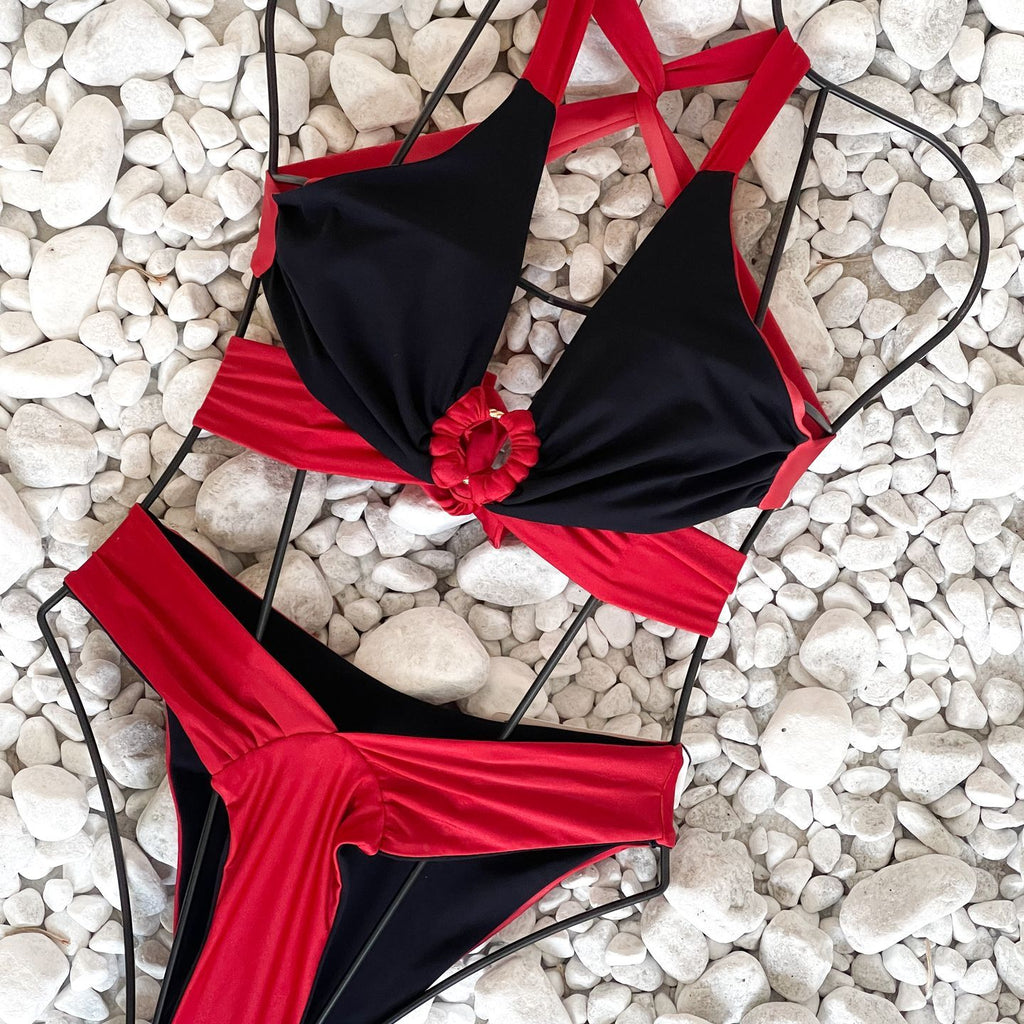 black and red bikini on white pebbles black and red bikini on white pebbles