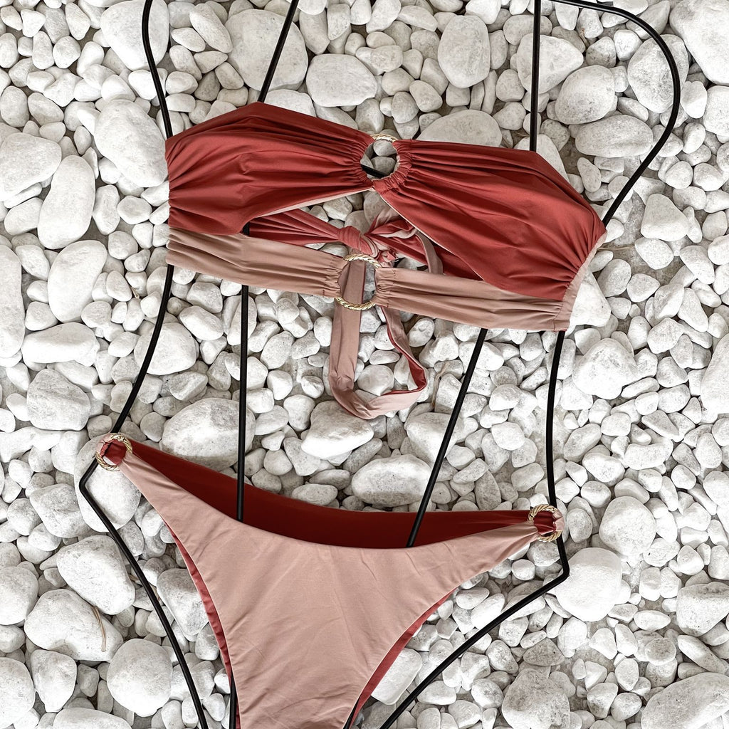 red and pink bikini on white pebbles red and pink bikini on white pebbles