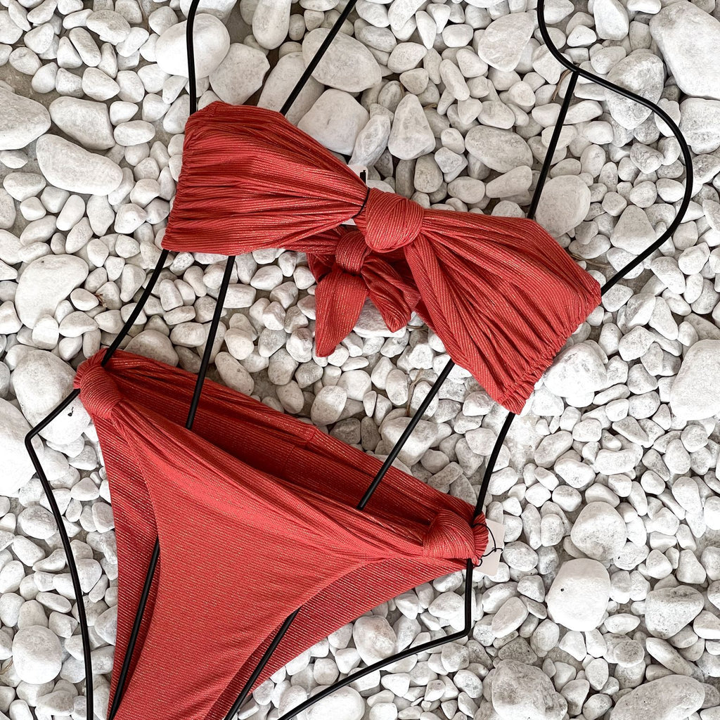red bikini on white pebbles red bikini on white pebbles