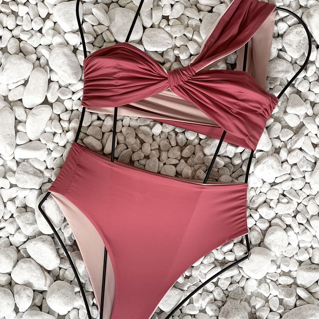 pink cutout swimsuit on white stones pink cutout swimsuit on white stones