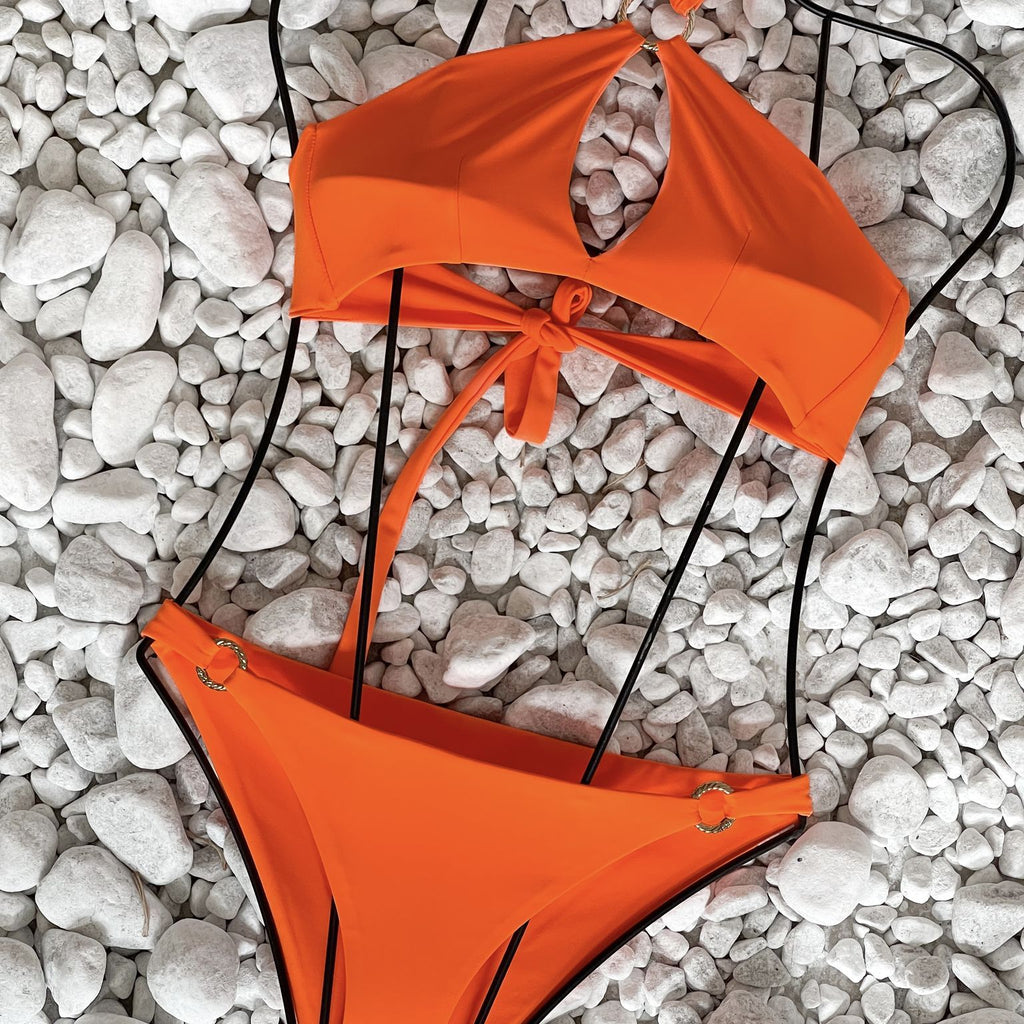 orange bikini on white stones orange bikini on white stones
