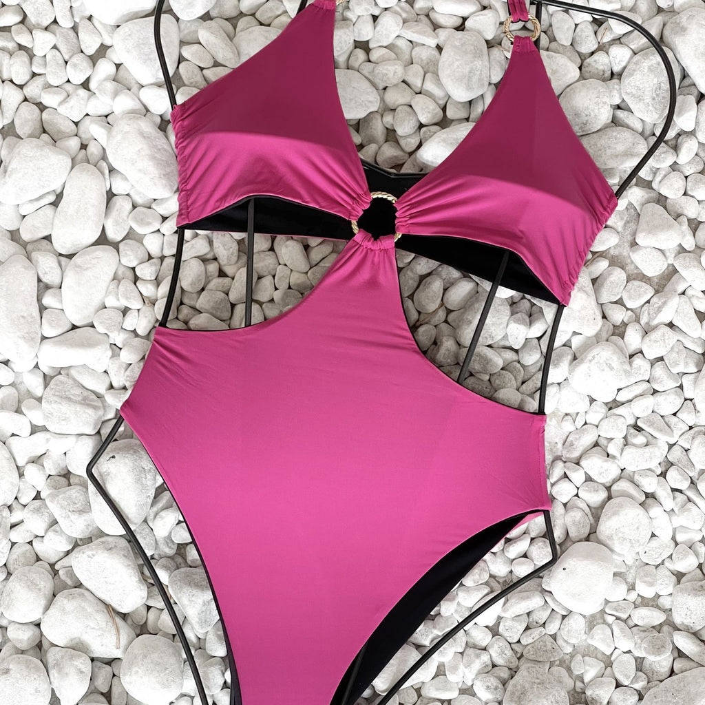 pink cutout one piece swimsuit on white pebbles pink cutout one piece swimsuit on white pebbles