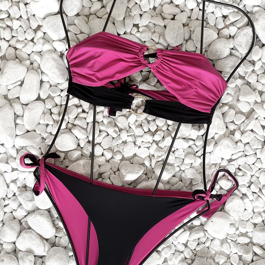 pink and black bikini on white pebbles pink and black bikini on white pebbles
