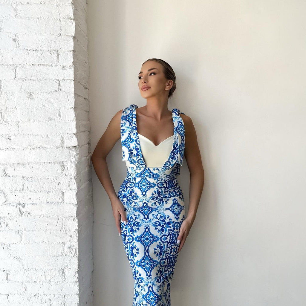 woman in blue and white patterned dress woman in blue and white patterned dress