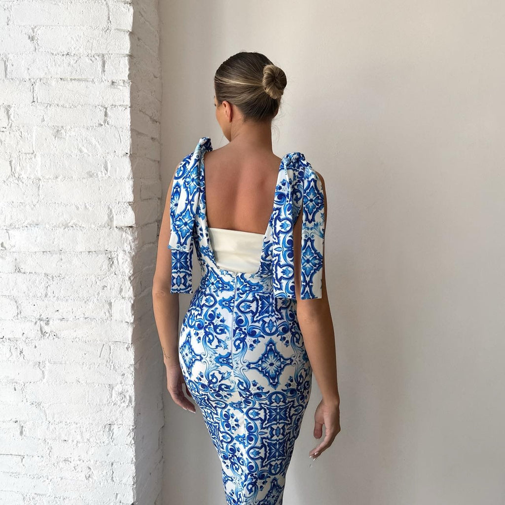 woman wearing blue and white patterned dress woman wearing blue and white patterned dress