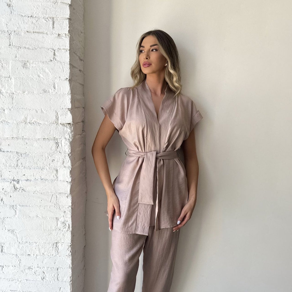 beige belted jumpsuit on woman in natural light beige belted jumpsuit on woman in natural light