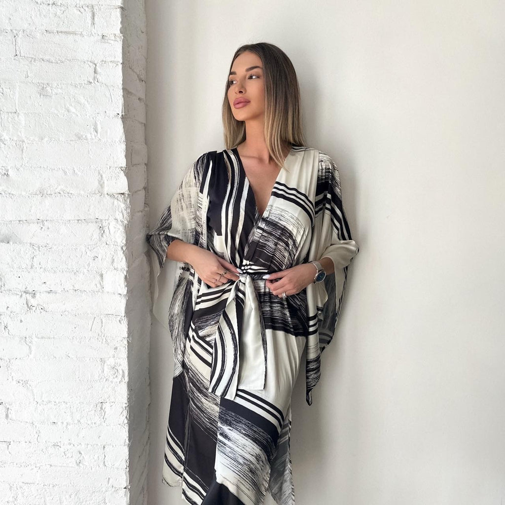 woman wearing black and white patterned dress woman wearing black and white patterned dress