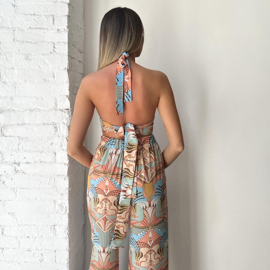 back view of woman in patterned backless jumpsuit back view of woman in patterned backless jumpsuit
