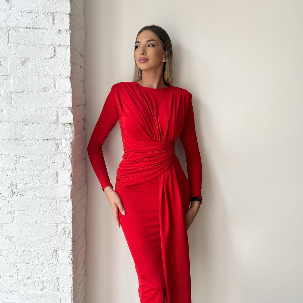 woman in red wrap dress against brick wall woman in red wrap dress against brick wall