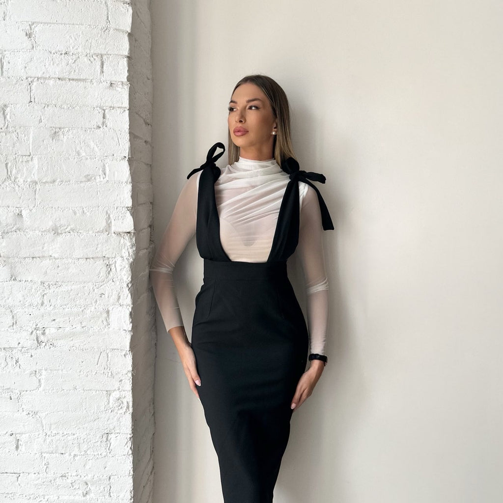 woman wearing black pencil dress with sheer white top woman wearing black pencil dress with sheer white top