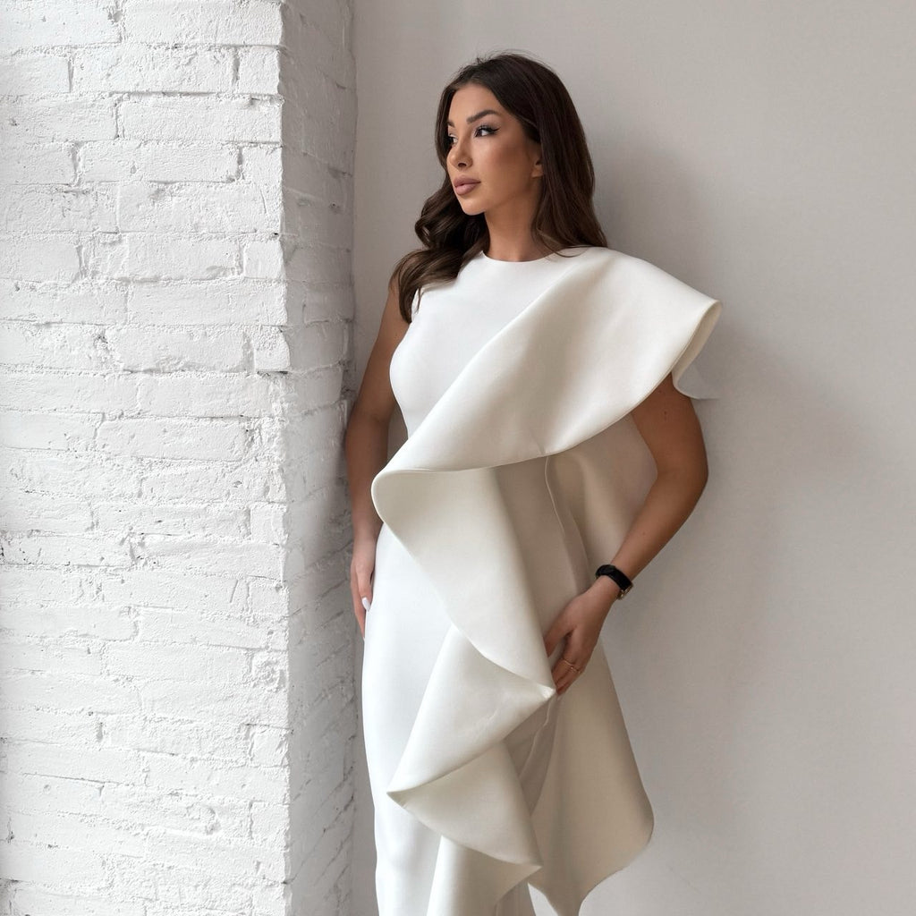 elegant white ruffled dress against brick wall elegant white ruffled dress against brick wall
