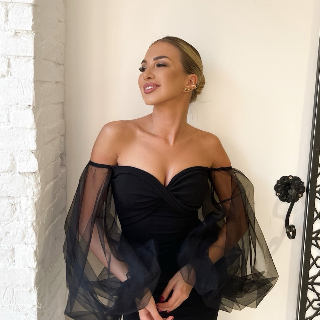 woman wearing off the shoulder black dress woman wearing off the shoulder black dress
