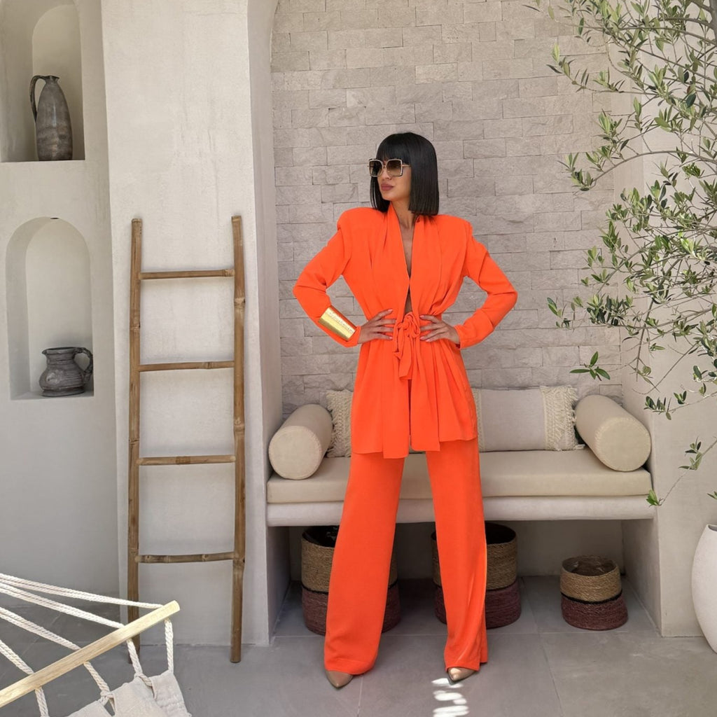 woman in bright orange suit in stylish modern setting woman in bright orange suit in stylish modern setting