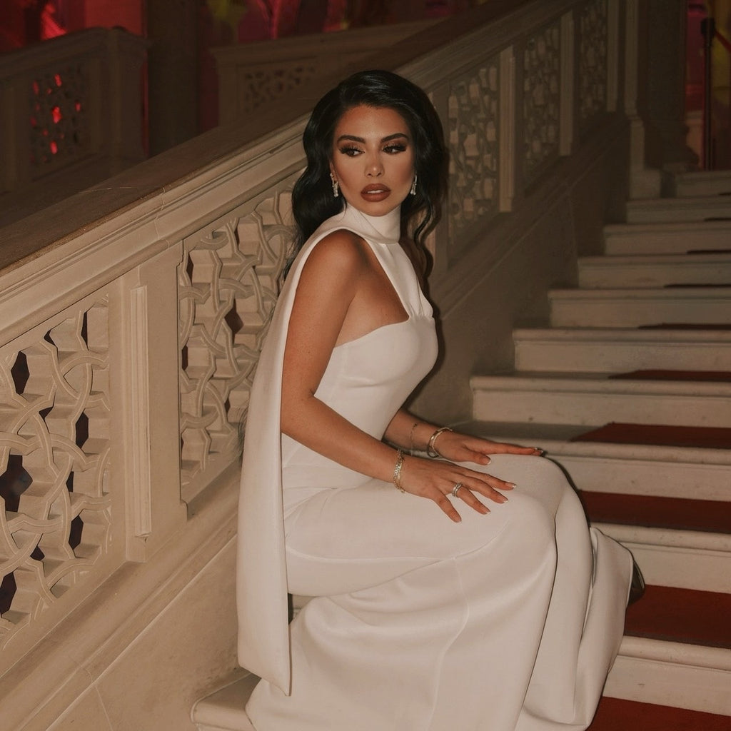 elegant woman in white evening gown sitting on stairs elegant woman in white evening gown sitting on stairs