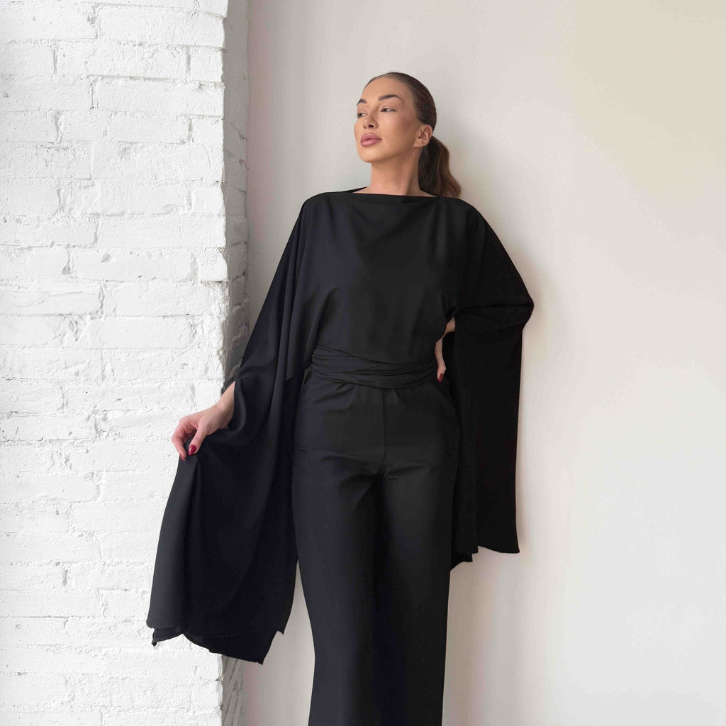 black elegant draped dress on model black elegant draped dress on model