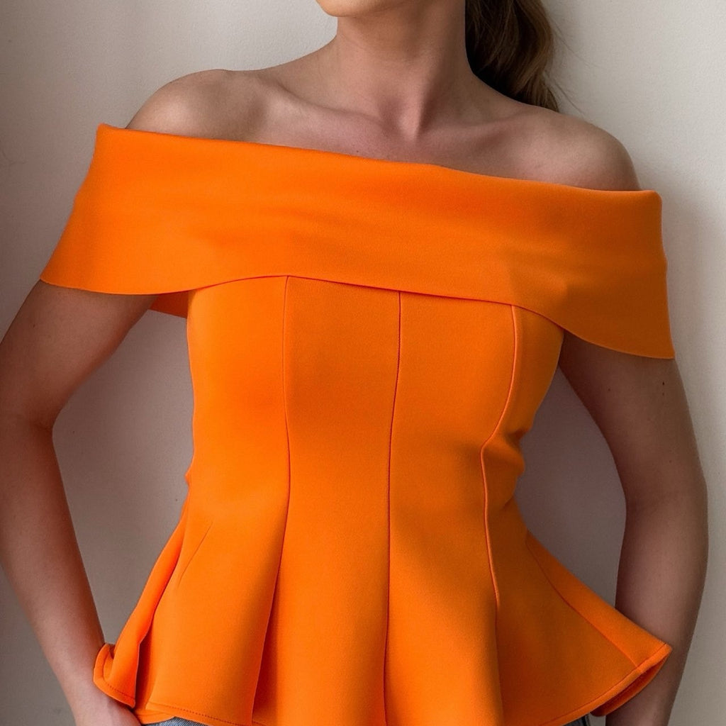 woman wearing orange off shoulder top and jeans woman wearing orange off shoulder top and jeans