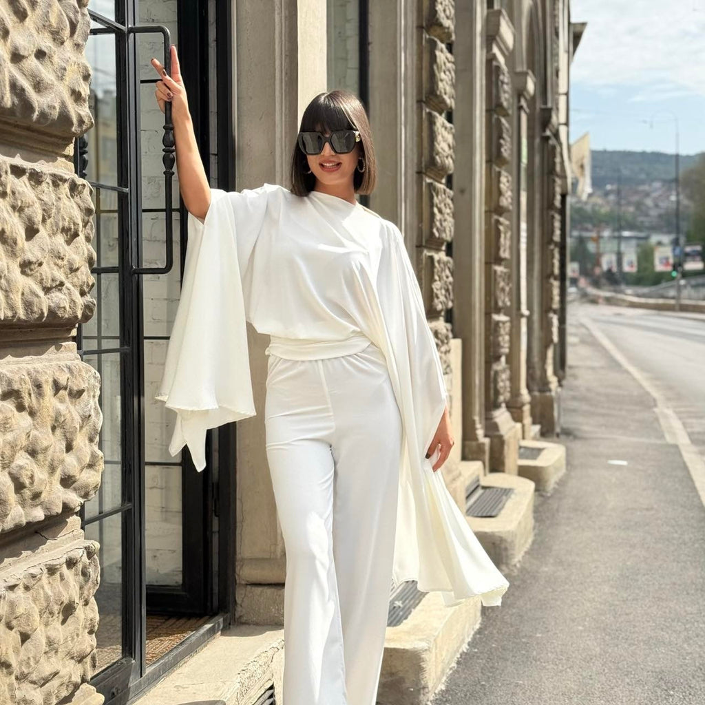 woman wearing elegant white outfit on city street woman wearing elegant white outfit on city street