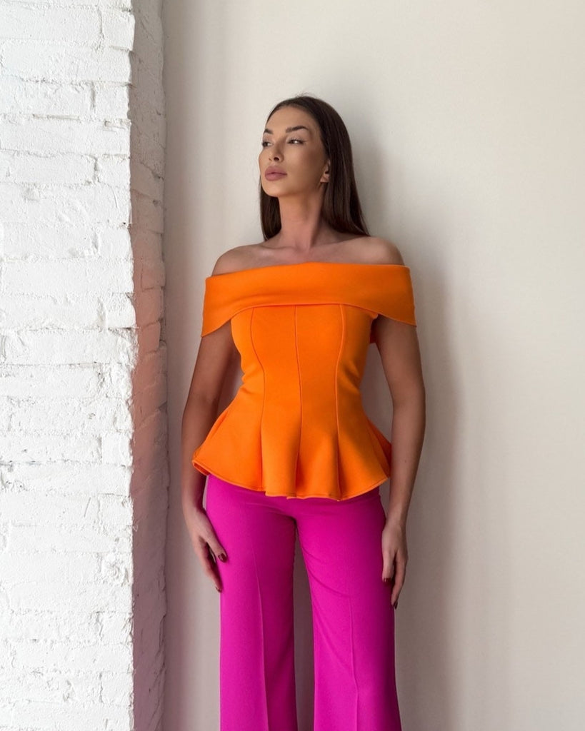woman wearing orange off shoulder top and pink pants woman wearing orange off shoulder top and pink pants